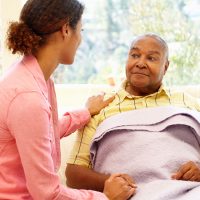 Woman looking after sick father Woman looking after sick father