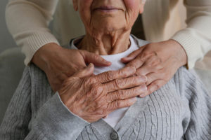 Unrecognizable female expressing care towards an elderly lady, h